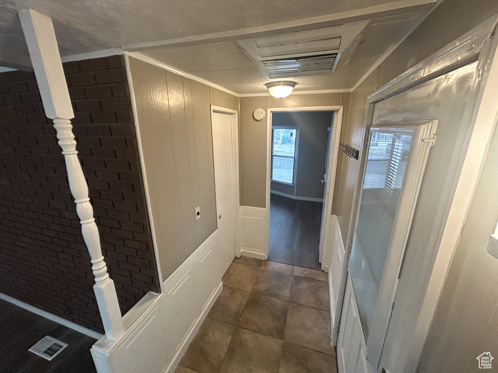 Hall with brick wall and crown molding