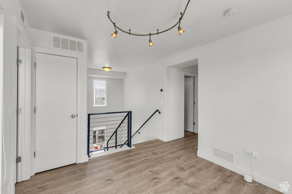 Empty room featuring a smoke detector and light wood-style flooring