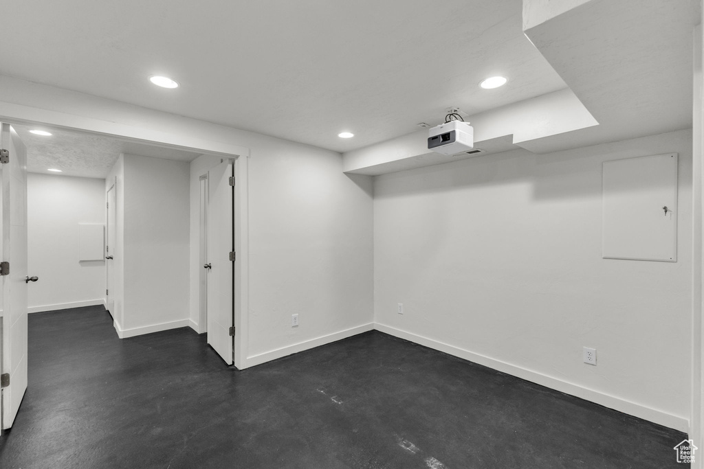 Finished basement with baseboards and recessed lighting