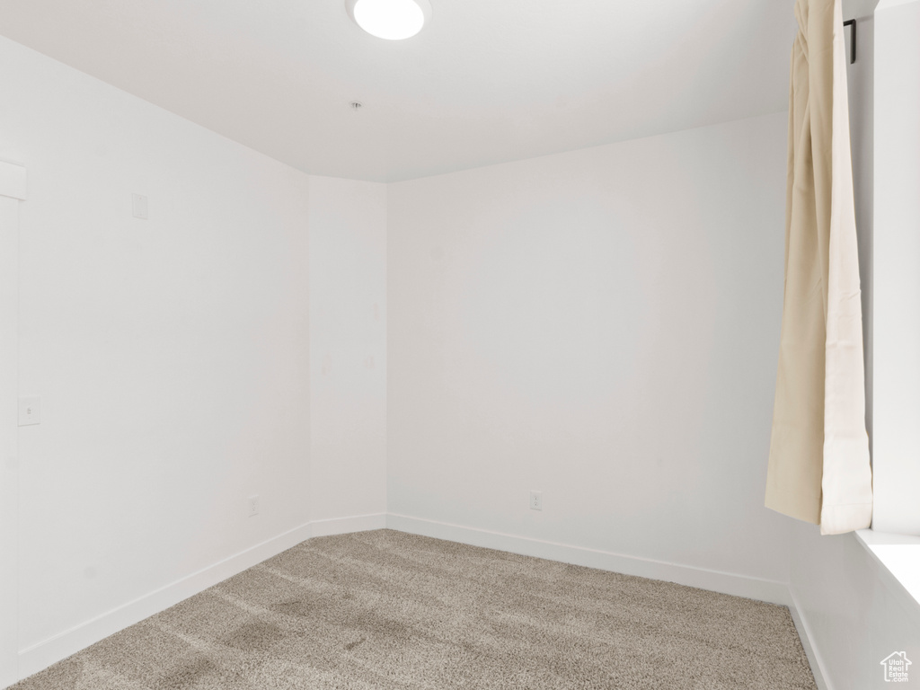 Unfurnished room with baseboards and carpet floors