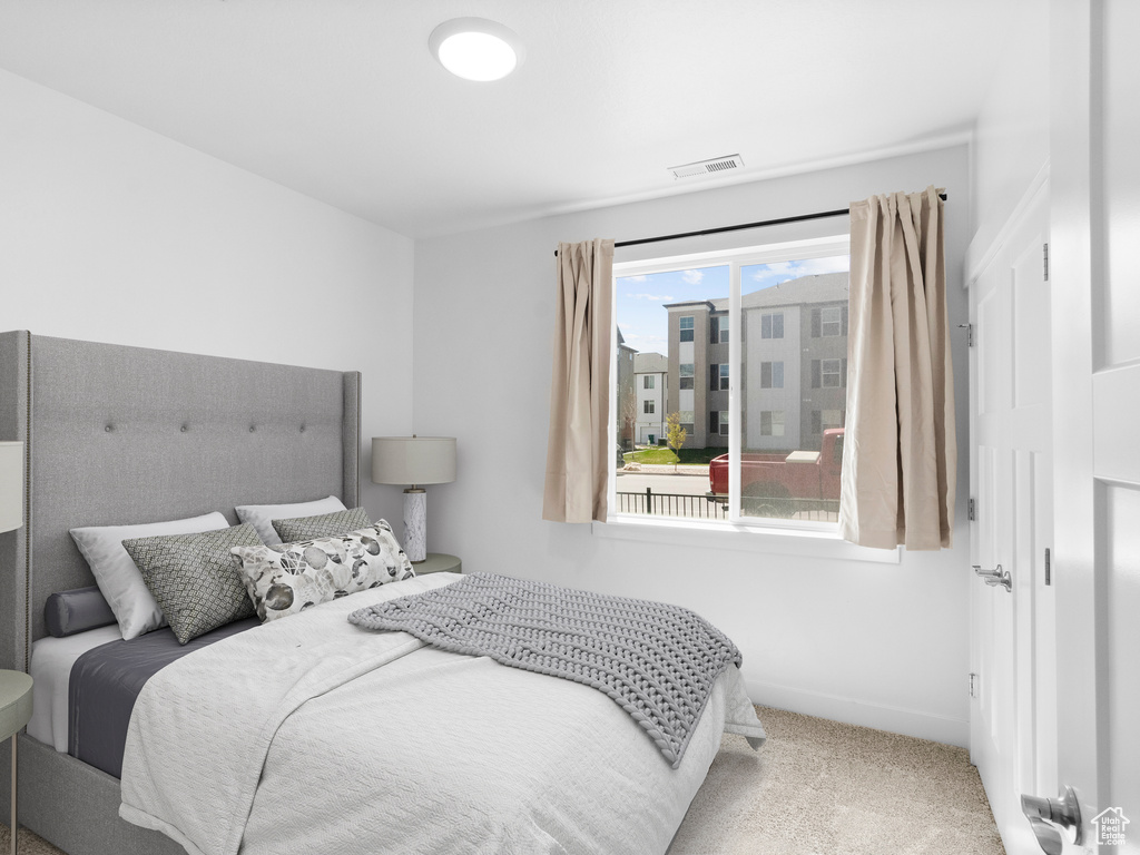 Bedroom featuring carpet and visible vents