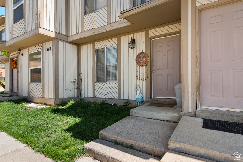Property entrance featuring board and batten siding