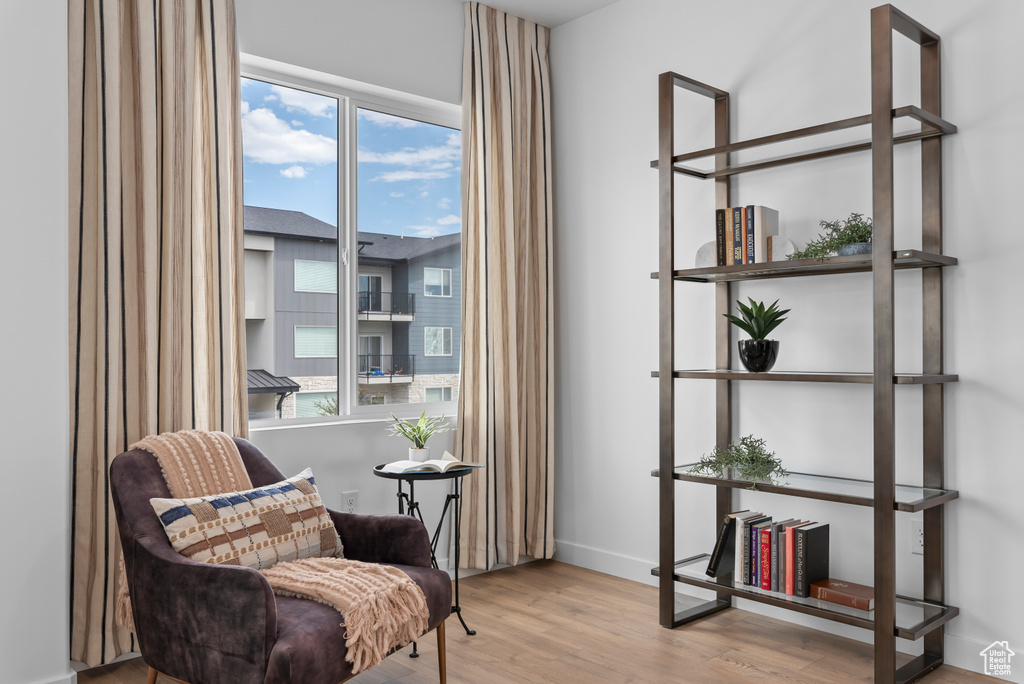 Living area featuring a healthy amount of sunlight, baseboards, and wood finished floors