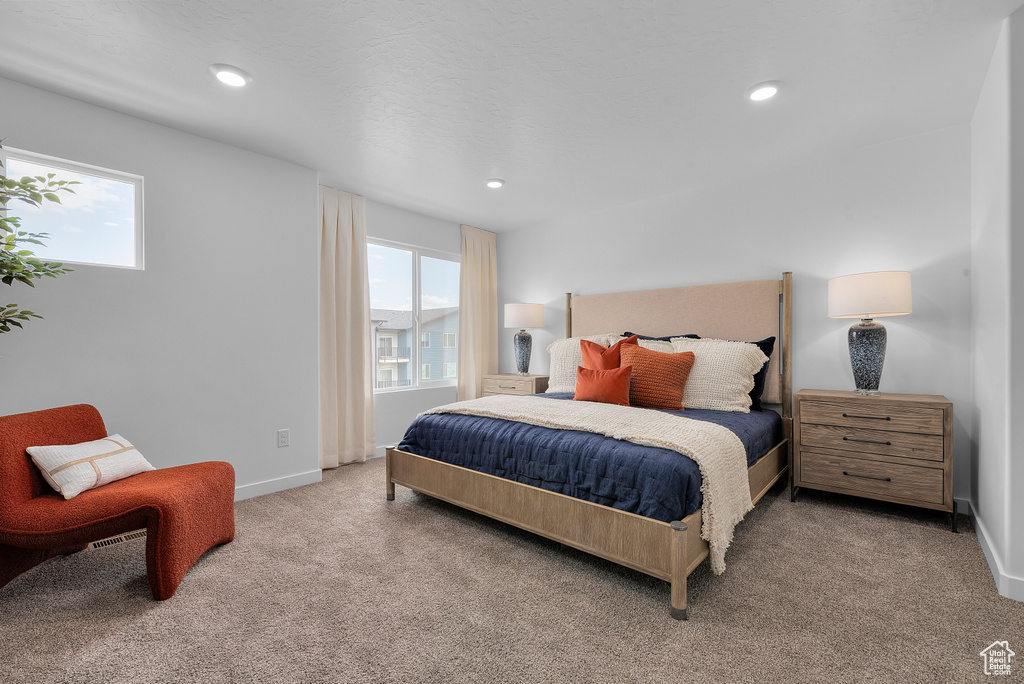 Bedroom featuring recessed lighting, multiple windows, baseboards, and carpet floors