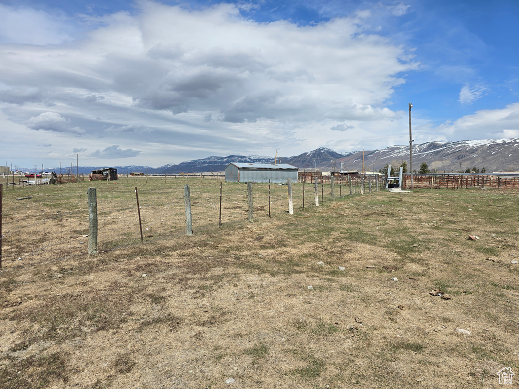 View of yard featuring a mountain view, fence, and a rural view