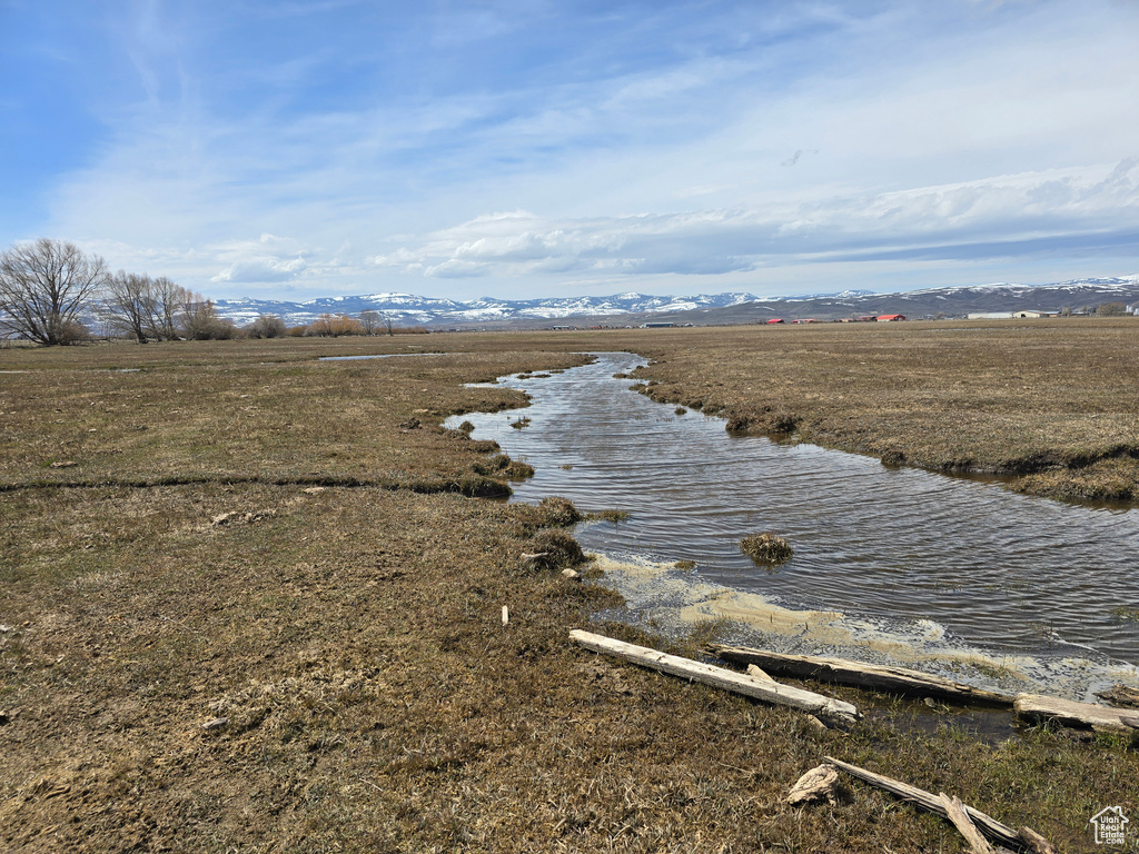 View of water feature with a mountain view