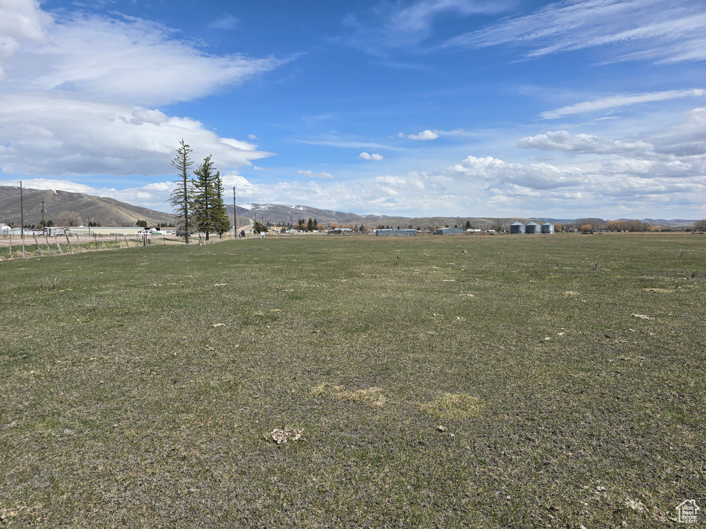 View of yard featuring a rural view and a mountain view