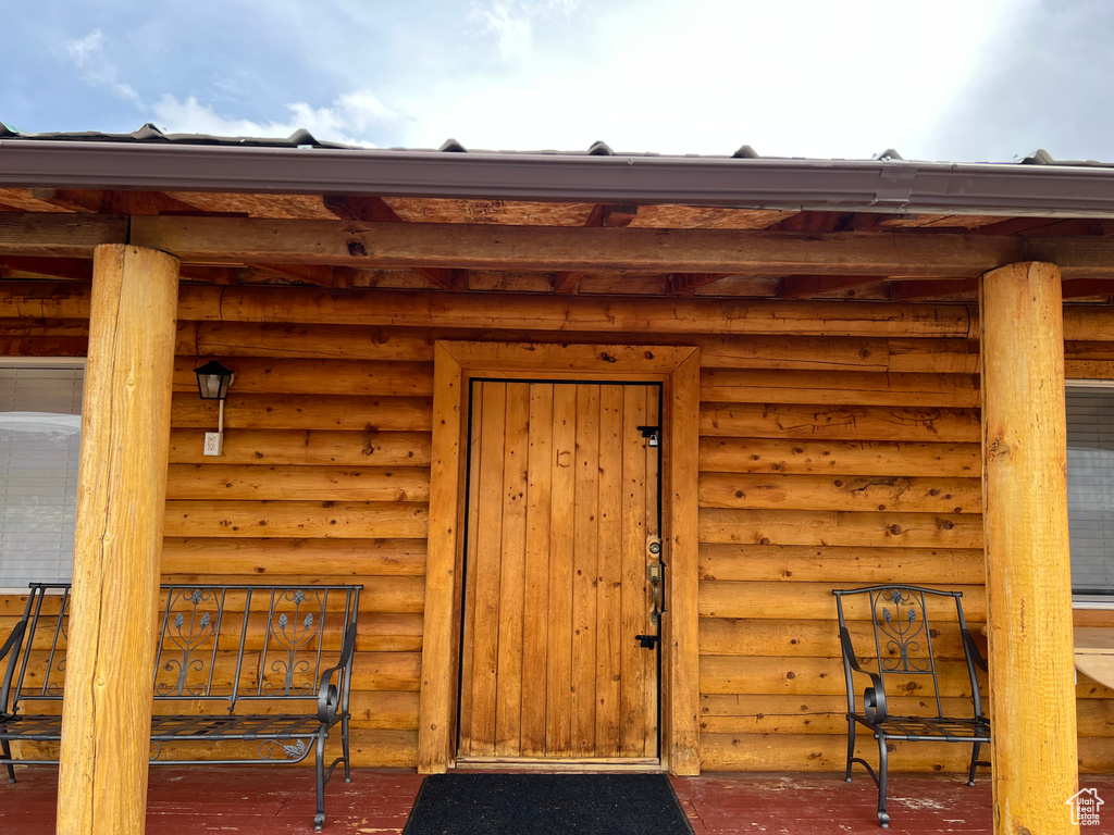 Entrance to property featuring log veneer siding