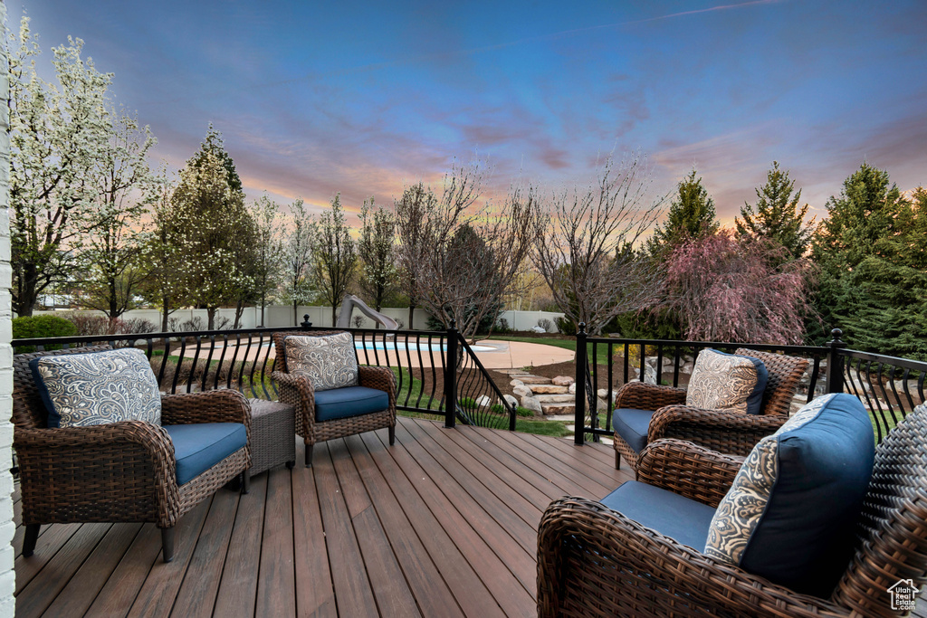 Wooden terrace with a fenced backyard and a fenced in pool