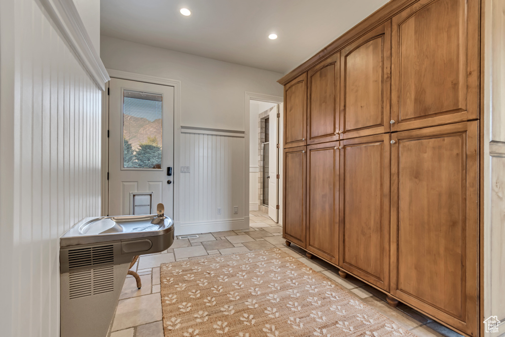 Mudroom with a decorative wall, recessed lighting, and wainscoting