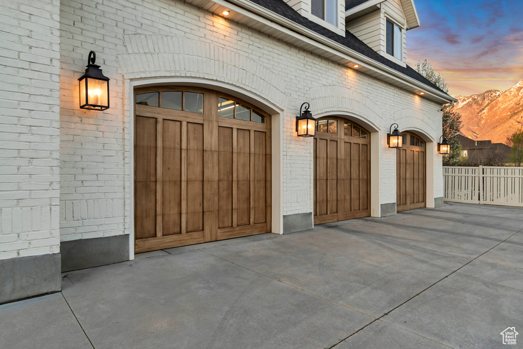 Garage with concrete driveway and a mountain view