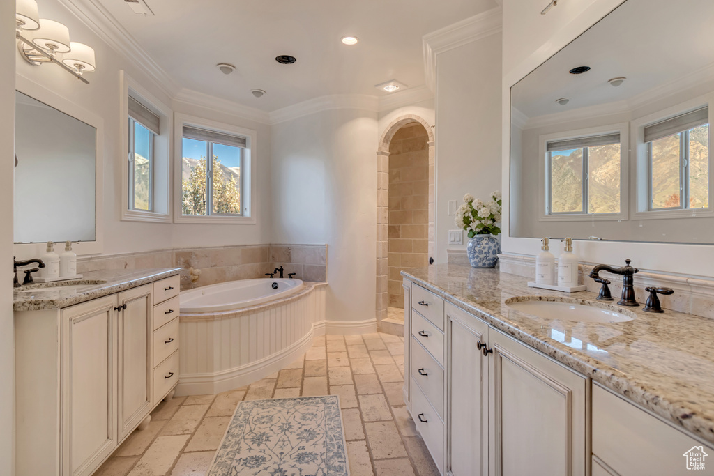 Bathroom featuring recessed lighting, a bath, a sink, and stone tile flooring