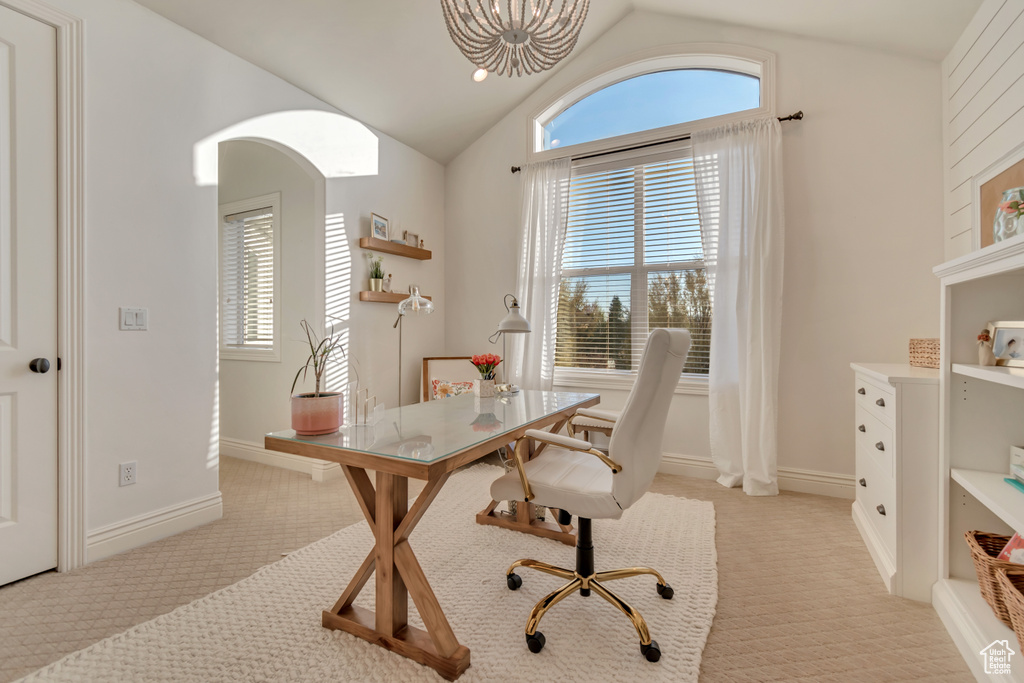 Office area featuring a chandelier, baseboards, light colored carpet, and vaulted ceiling