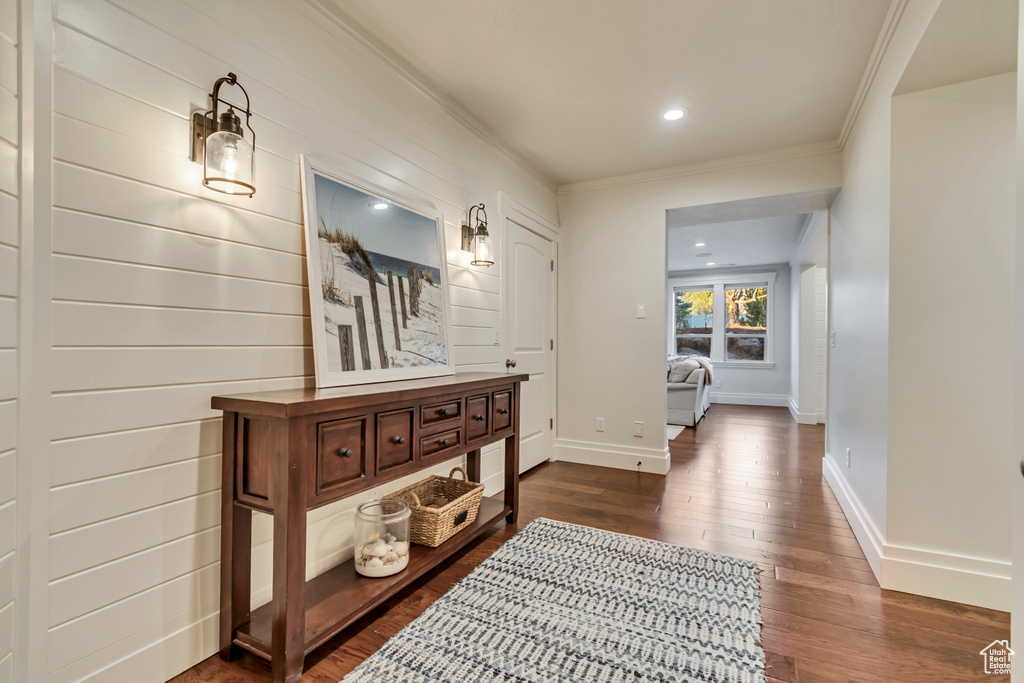 Hallway featuring ornamental molding, baseboards, dark wood-style floors, and recessed lighting
