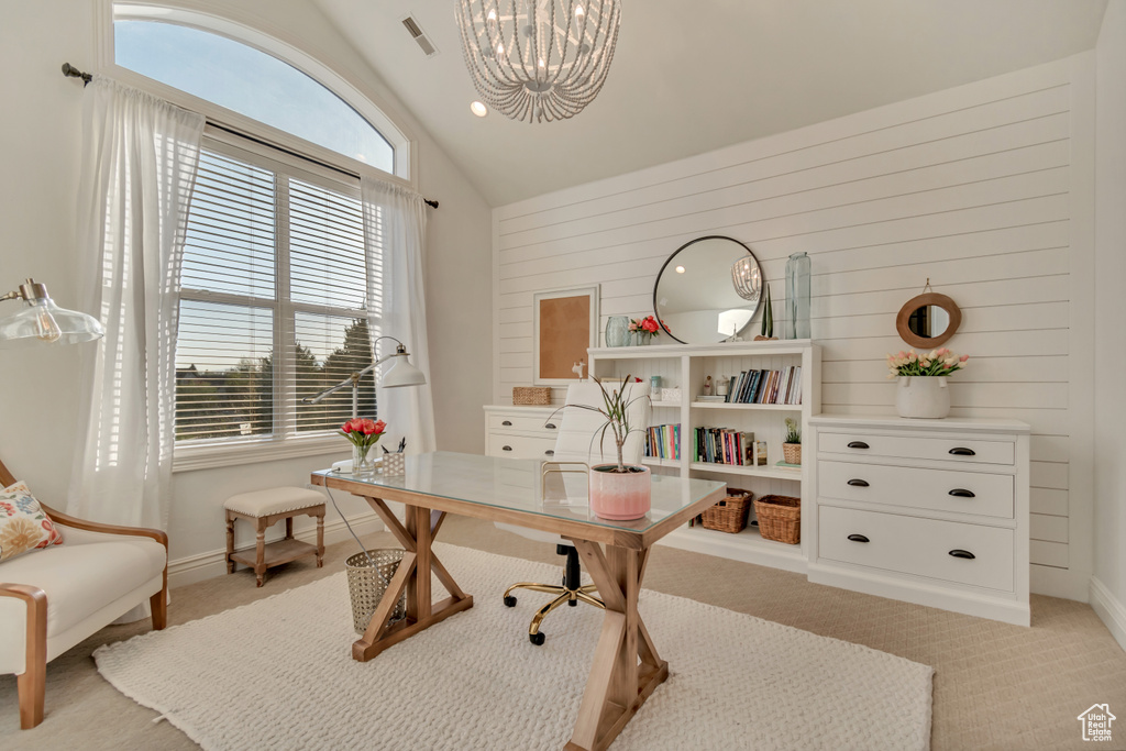 Office with wooden walls, visible vents, a chandelier, and light carpet