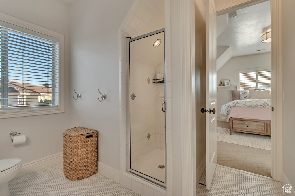 Bathroom featuring a shower stall, ensuite bathroom, baseboards, and toilet