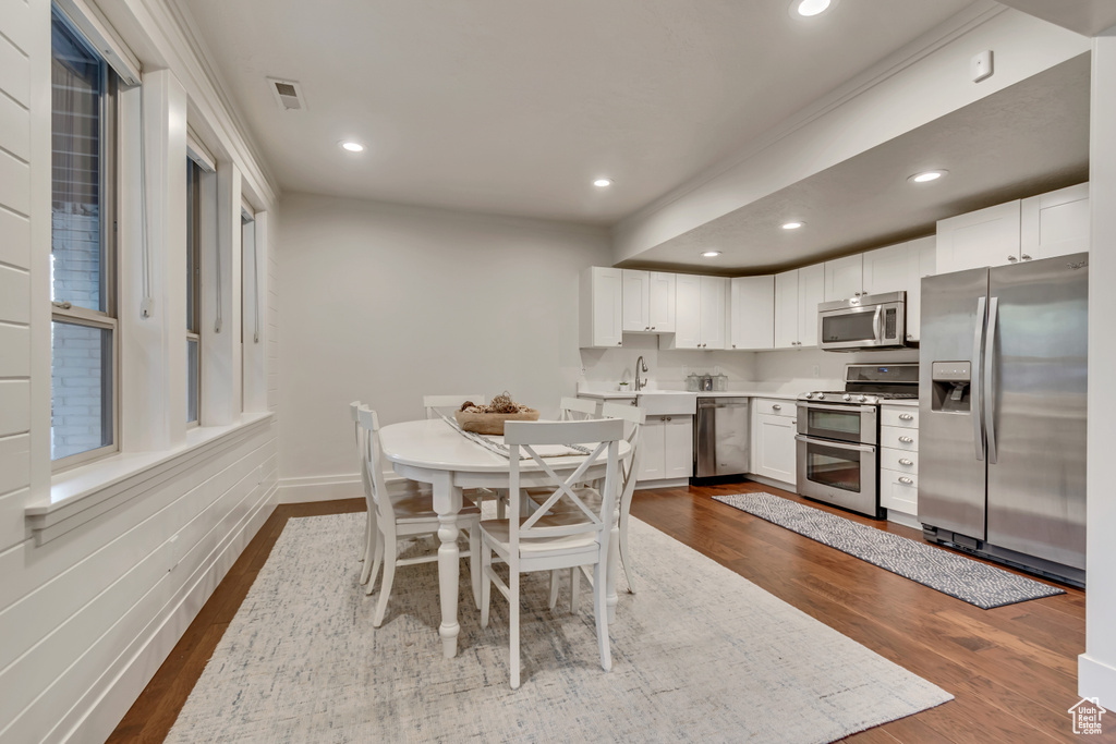Dining room with dark wood-style flooring, visible vents, baseboards, and recessed lighting
