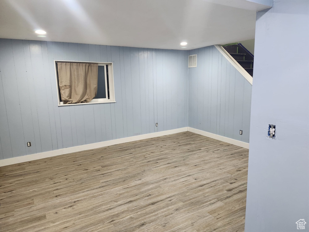 Finished basement featuring wood finished floors, baseboards, and recessed lighting
