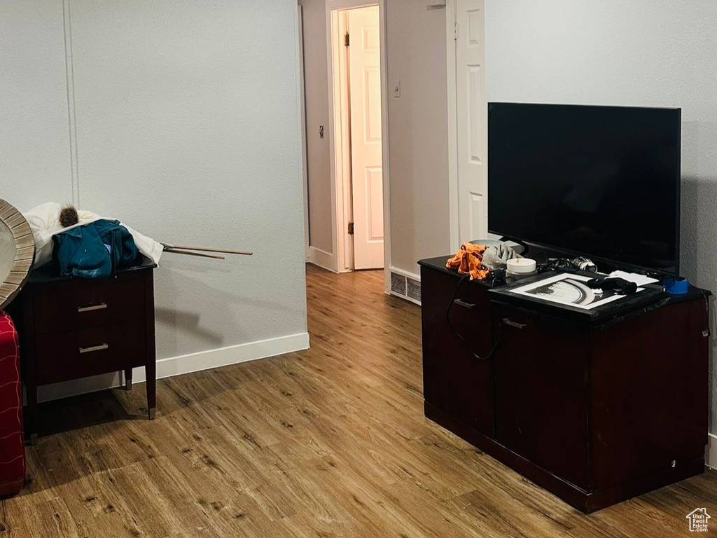Living area with baseboards and wood finished floors
