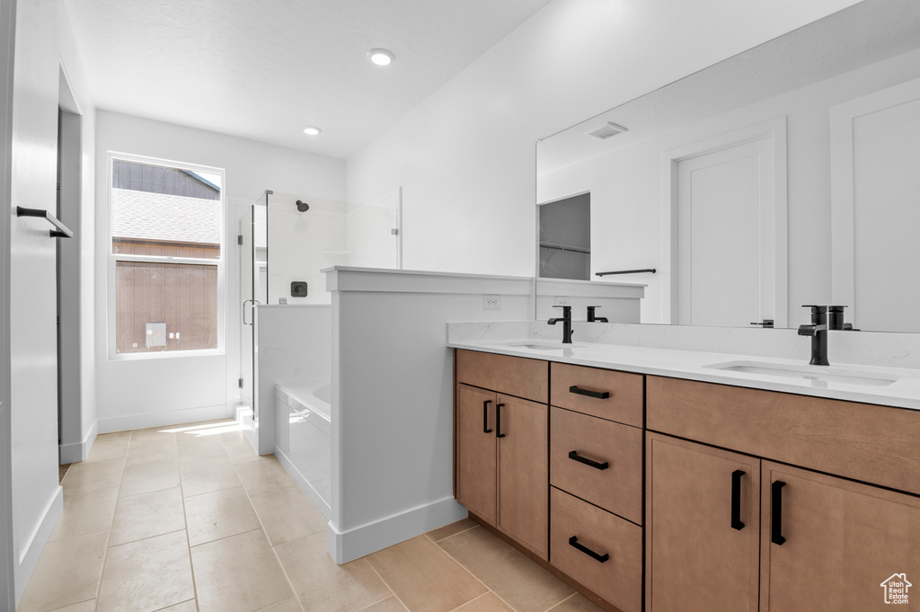 Bathroom featuring an enclosed shower, double vanity, a garden tub, tile patterned flooring, and recessed lighting
