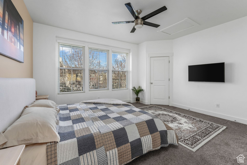 Bedroom with carpet floors, baseboards, attic access, and ceiling fan