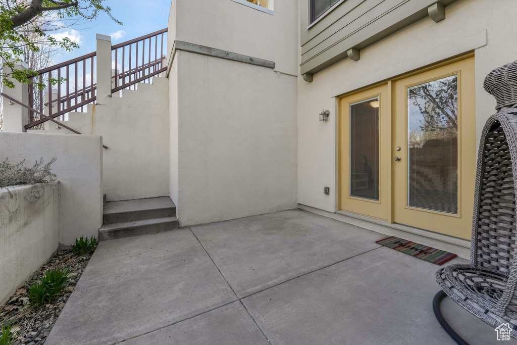 View of exterior entry featuring a patio area and stucco siding