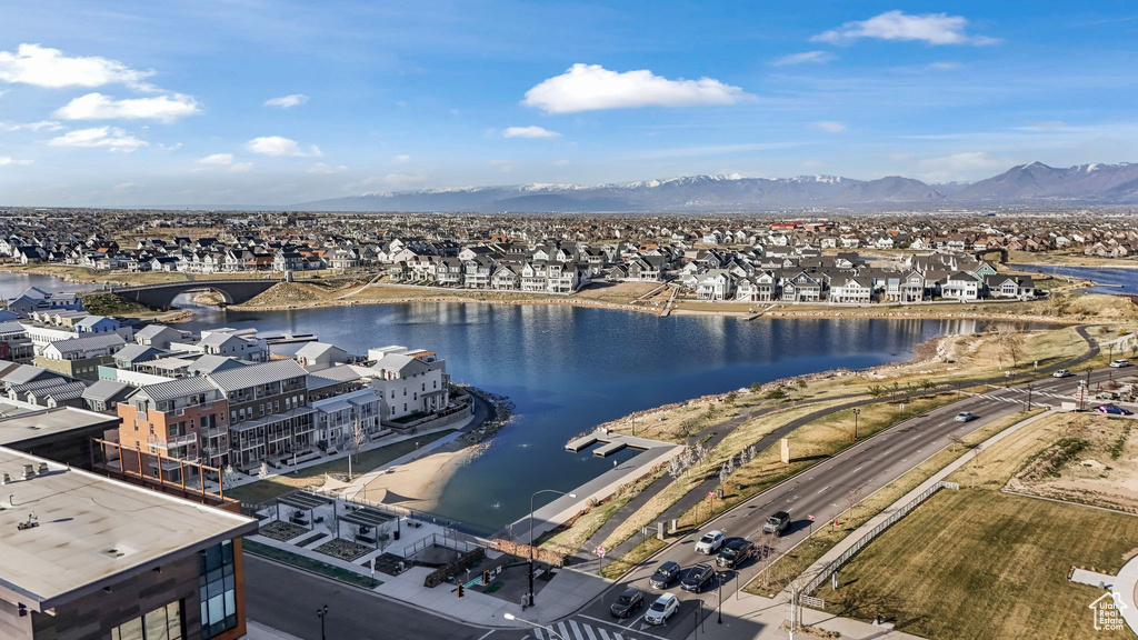 Drone / aerial view with a water and mountain view and a residential view