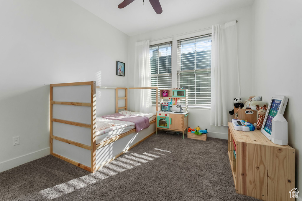 Bedroom with carpet, baseboards, and a ceiling fan