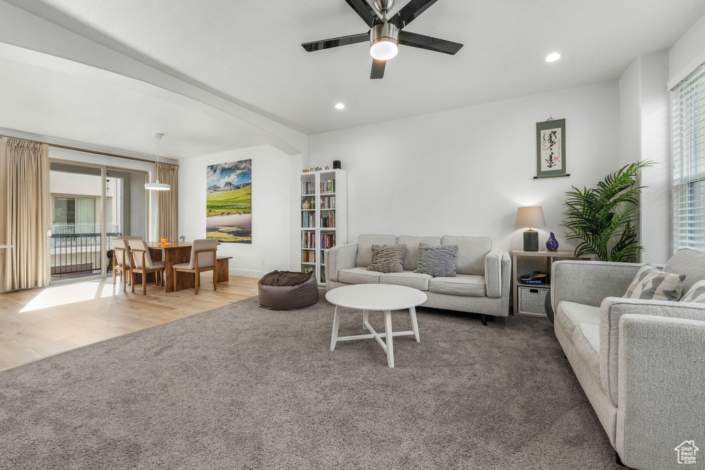 Living room featuring recessed lighting, carpet flooring, wood finished floors, and ceiling fan