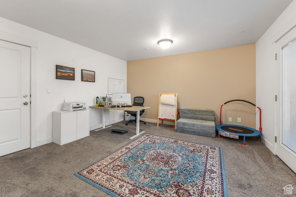 Home office with baseboards and carpet