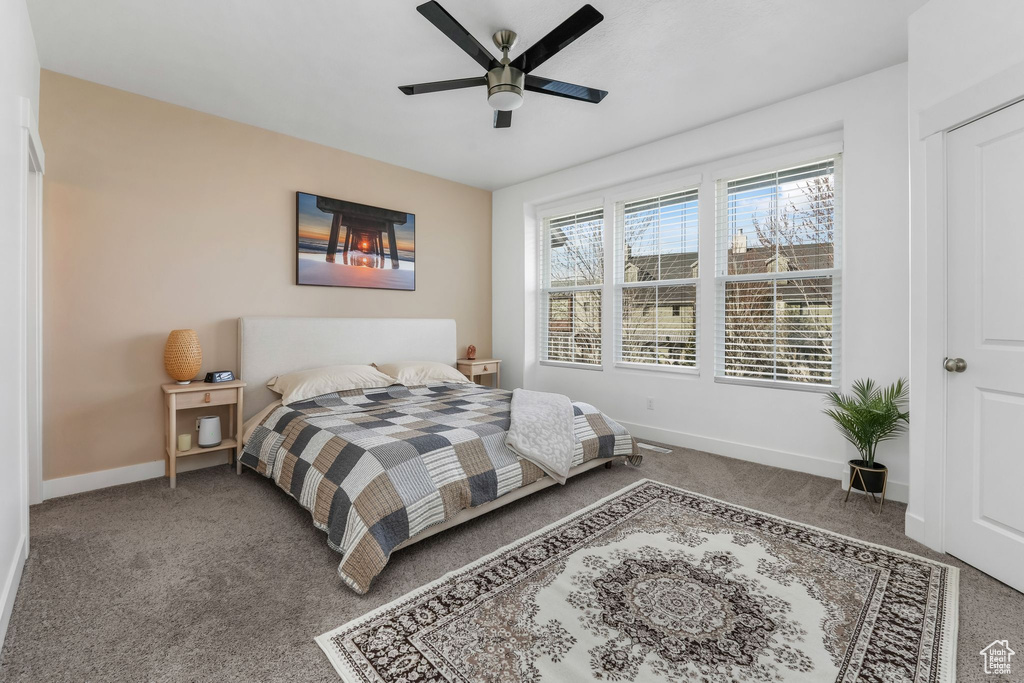Bedroom featuring baseboards, a ceiling fan, and carpet floors