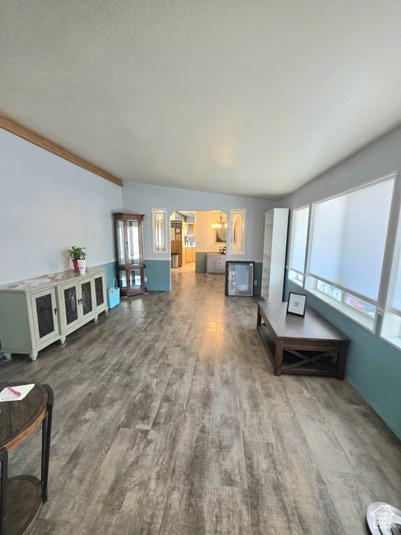 Living room with wood finished floors and a textured ceiling