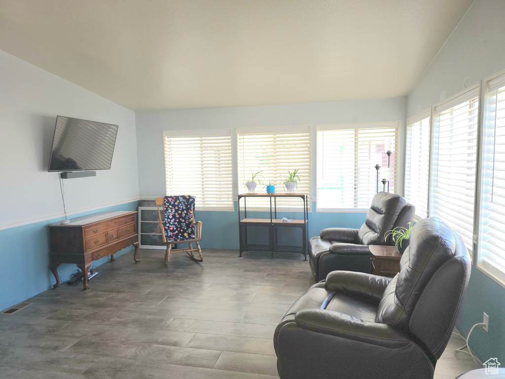 Living room featuring wood finished floors and vaulted ceiling
