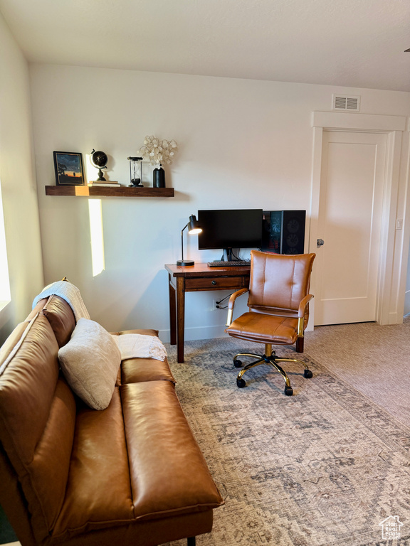 Carpeted office space with baseboards