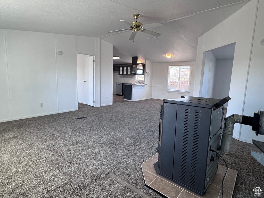Living area featuring lofted ceiling, ceiling fan, and carpet floors