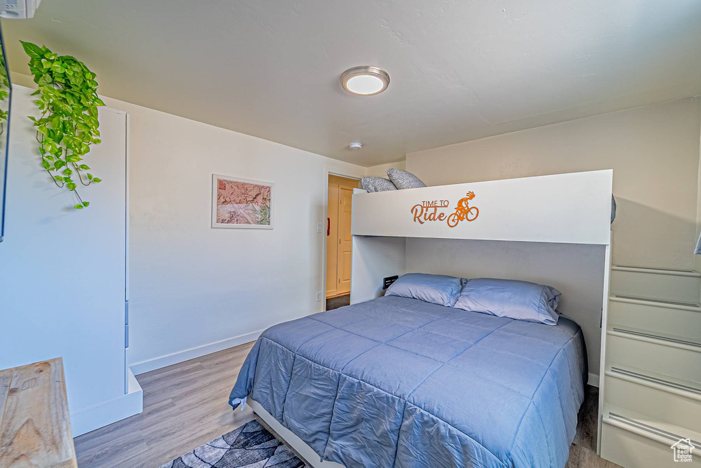 Bedroom featuring light wood finished floors and baseboards