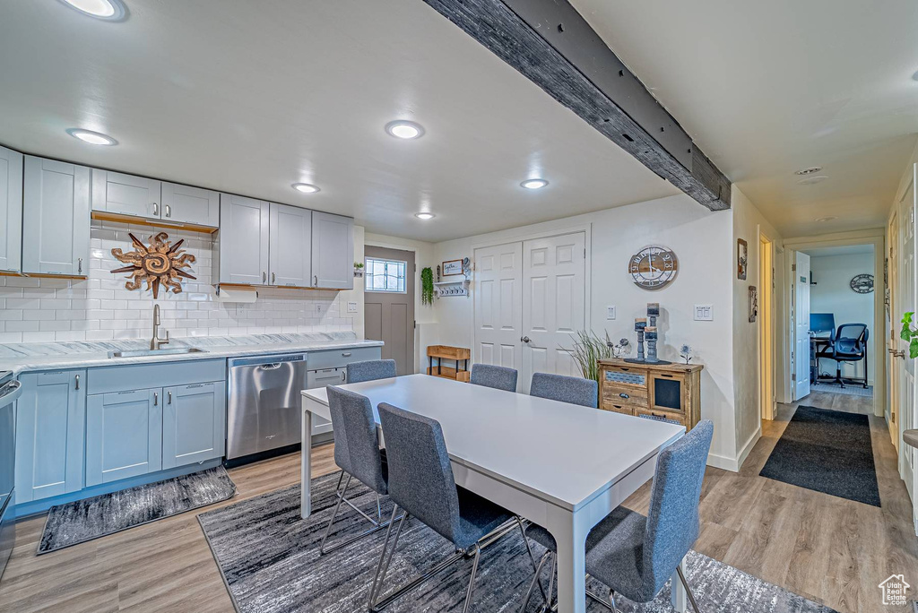 Dining area featuring baseboards, light wood finished floors, and recessed lighting