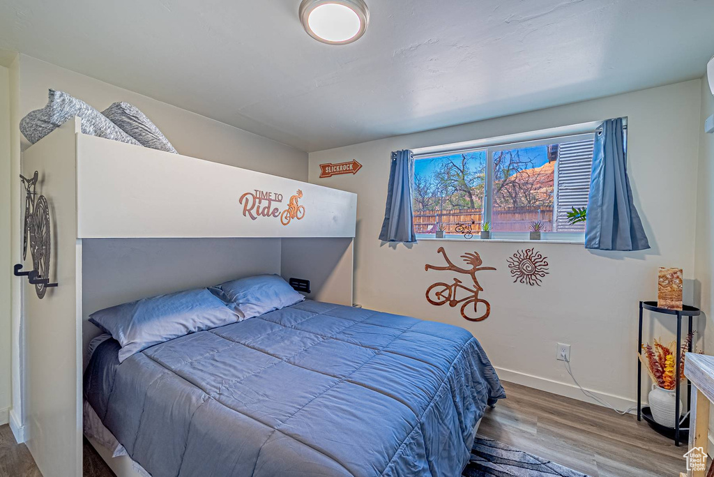 Bedroom featuring wood finished floors and baseboards
