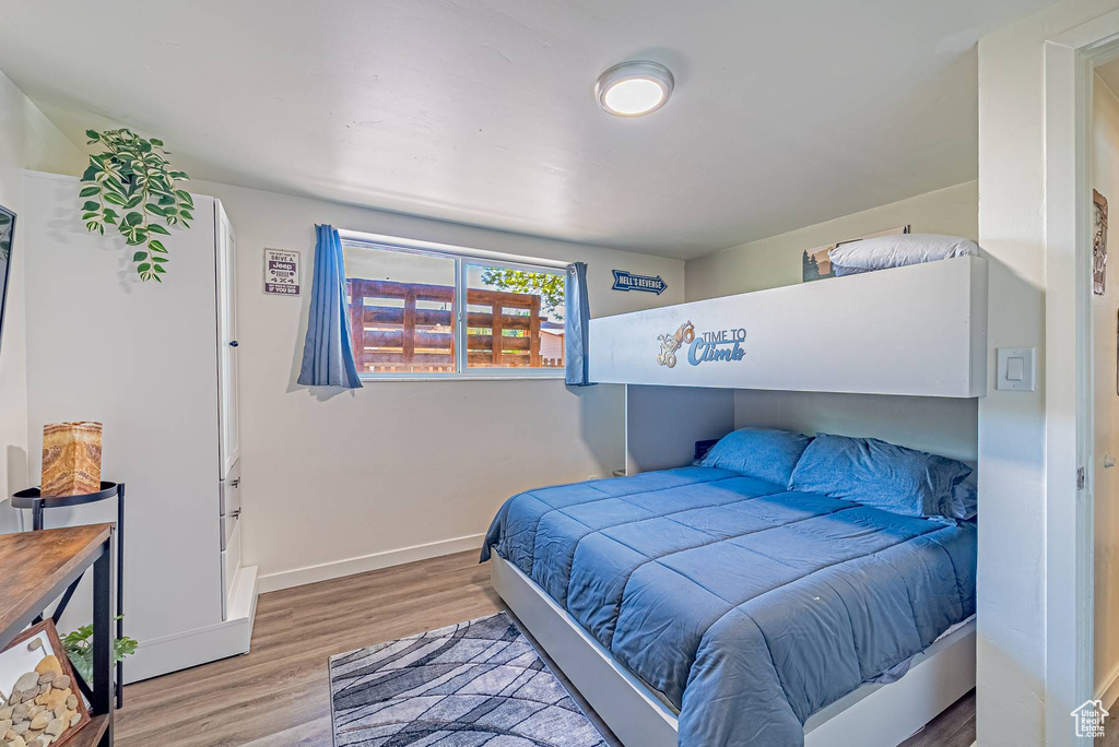 Bedroom featuring light wood finished floors and baseboards