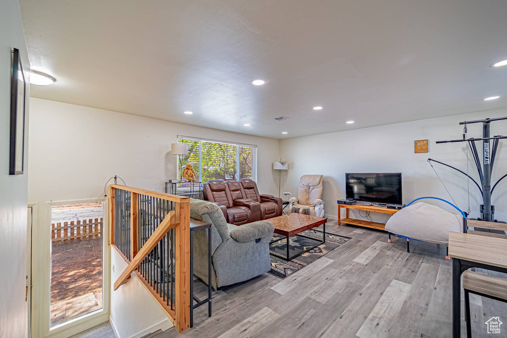 Living room featuring wood finished floors, baseboards, and recessed lighting