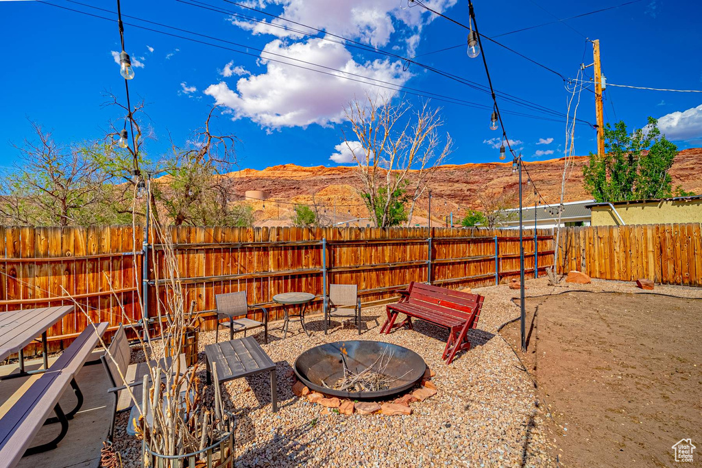 View of yard featuring a patio area, a fenced backyard, and an outdoor fire pit