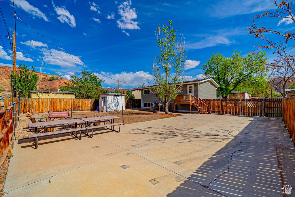 View of patio / terrace featuring a fenced backyard, an outdoor structure, and a storage unit