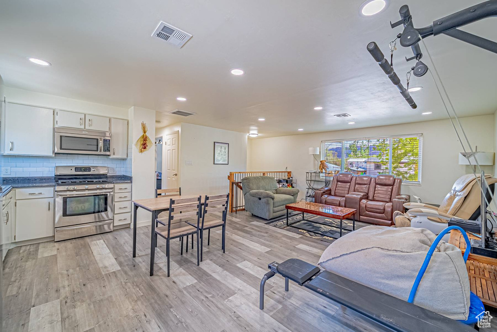 Living area featuring visible vents, recessed lighting, and light wood-style floors