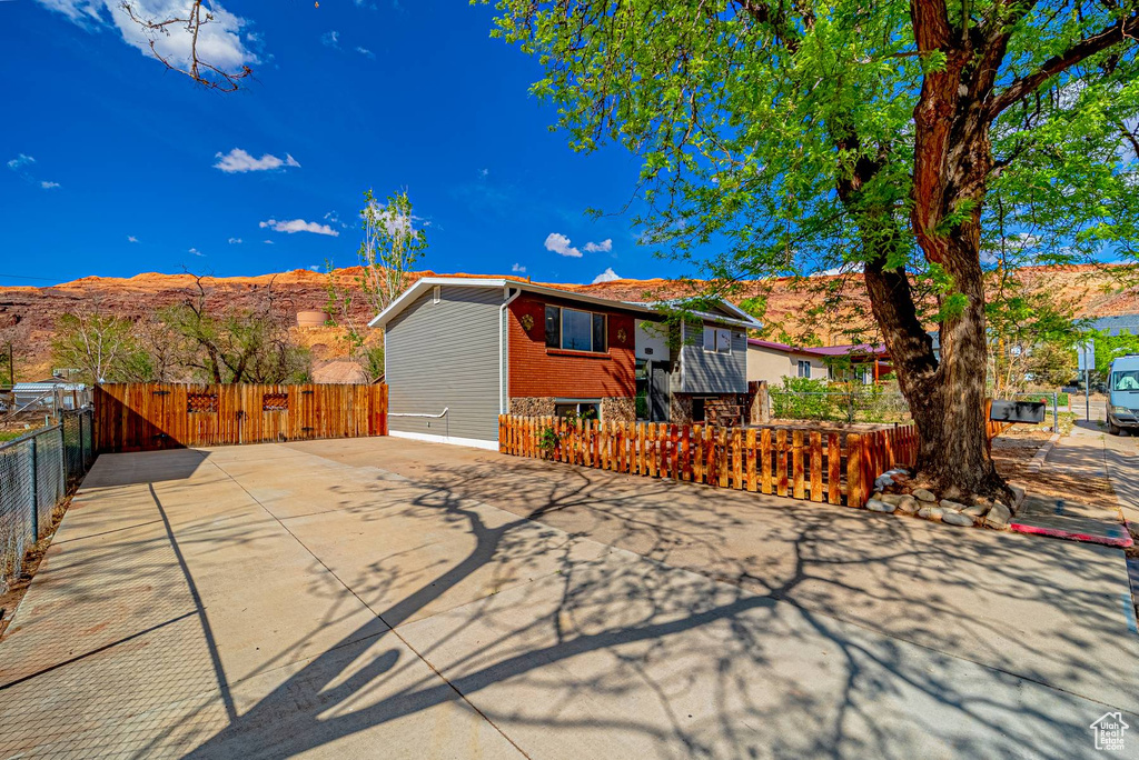 View of front of house featuring brick siding and fence