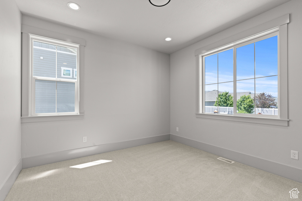 Carpeted empty room with recessed lighting
