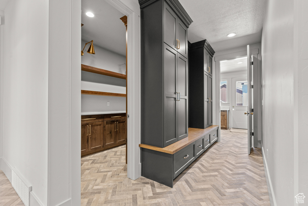 Mudroom with recessed lighting and a textured ceiling