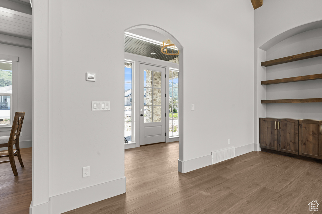 Entrance foyer featuring wood finished floors and healthy amount of natural light