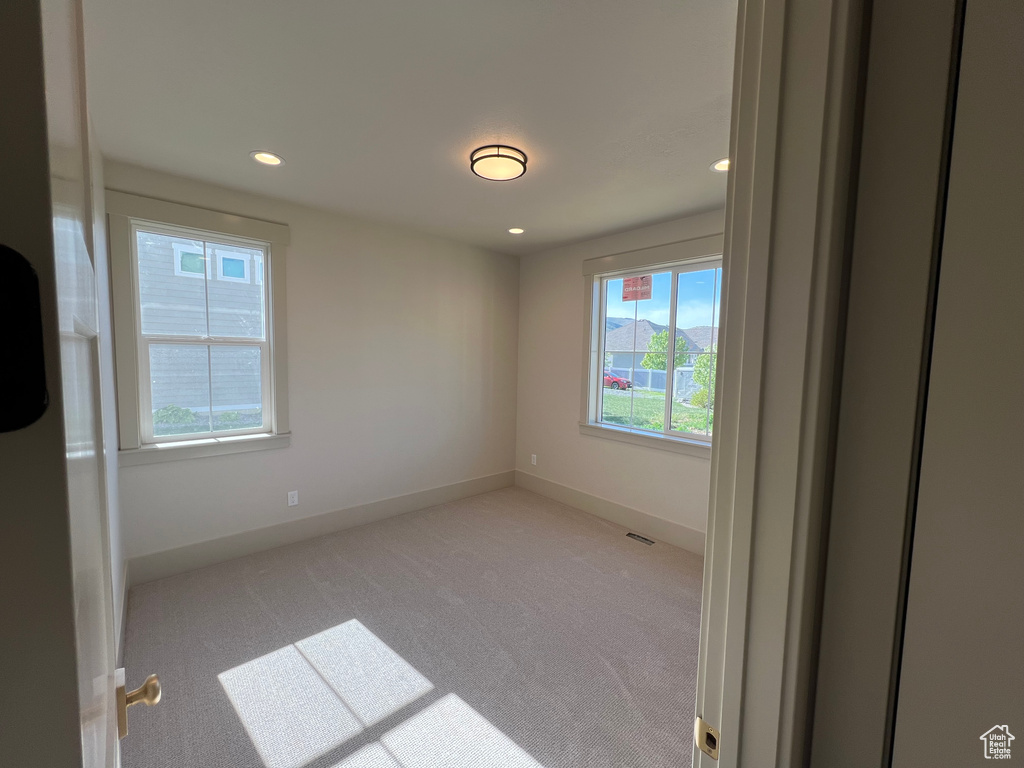 Unfurnished room featuring carpet flooring, baseboards, and recessed lighting