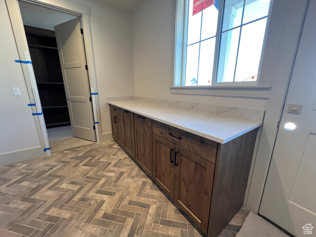 Bathroom featuring brick patterned flooring and baseboards