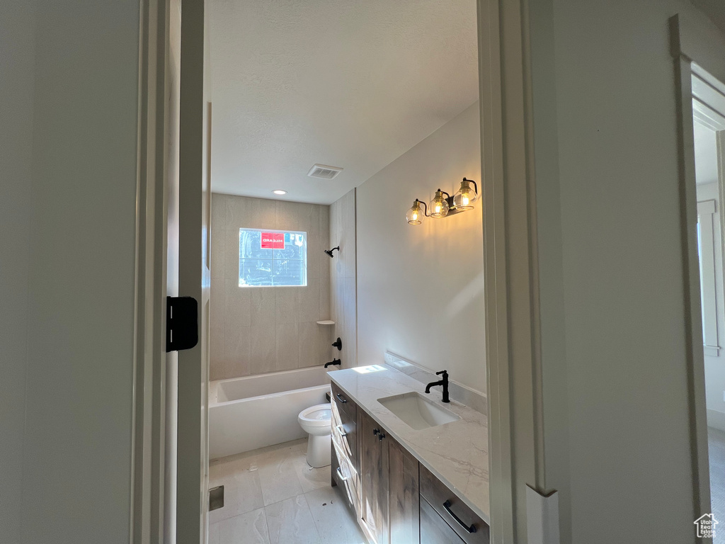 Full bath featuring vanity, toilet, and  shower combination